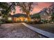 Brick home with walkway, landscaping, and a sunset view at 122 Cainhoy Landing Rd, Charleston, SC 29492