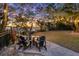 Cozy firepit with seating under string lights at 122 Cainhoy Landing Rd, Charleston, SC 29492