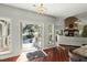 Open kitchen with island, hardwood floors, and views to living room and deck at 122 Cainhoy Landing Rd, Charleston, SC 29492
