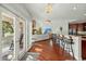 Open kitchen with island, hardwood floors, and views to living room and deck at 122 Cainhoy Landing Rd, Charleston, SC 29492