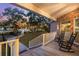 Relaxing porch with rocking chairs offering waterfront sunset views at 122 Cainhoy Landing Rd, Charleston, SC 29492