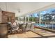 Relaxing screened porch with wooden floors, comfy seating, and pool views at 122 Cainhoy Landing Rd, Charleston, SC 29492