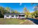 Newly renovated house featuring a pink door and landscaped yard at 211 Water Wheel Rd, Ridgeville, SC 29472