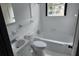 Small bathroom with a tub, toilet and sink at 220 Thompson St, Walterboro, SC 29488