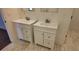Bathroom with double vanity and updated flooring at 220 Thompson St, Walterboro, SC 29488