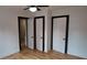Bedroom with hardwood floors and three closets at 220 Thompson St, Walterboro, SC 29488