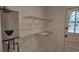 Laundry room with shelving and new water heater at 220 Thompson St, Walterboro, SC 29488