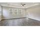 Spacious living room with three windows, hardwood floors, and a ceiling fan at 244 Mcmakin Dr, Summerville, SC 29483
