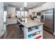 Modern kitchen with white cabinets, granite island, and stainless steel appliances at 443 Switchgrass Dr, Summerville, SC 29486