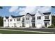 Row of charming 2-story townhouses with attached garages and light blue siding at 8785 Silver Perch Ln, North Charleston, SC 29420