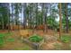 Private backyard with wooden swing set, fire pit, and garden at 119 Osage Way, Summerville, SC 29483