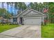Gray house with 2-car garage and American flag, RV in background at 119 Osage Way, Summerville, SC 29483