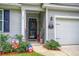 Front entry with door, welcome sign, and potted plants at 119 Osage Way, Summerville, SC 29483