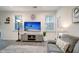 Living room with gray sofa, TV, and floor lamp at 119 Osage Way, Summerville, SC 29483