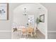 Dining room featuring a wooden table, white chairs, and an arched entryway at 1216 Fort Dr, Hanahan, SC 29410