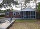 Brick home with screened porch and patio at 1278 S Lenevar Dr, Charleston, SC 29407