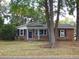 Charming brick ranch house with large trees in the front yard at 1278 S Lenevar Dr, Charleston, SC 29407
