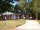 Brick ranch home with a paved driveway and landscaped lawn at 1278 S Lenevar Dr, Charleston, SC 29407