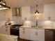 Modern white kitchen with marble backsplash and stainless steel appliances at 1278 S Lenevar Dr, Charleston, SC 29407