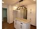 White kitchen island with granite countertop and black hardware at 1278 S Lenevar Dr, Charleston, SC 29407