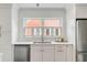 White kitchen with marble countertops, stainless steel appliances, and shuttered window at 14 Chadwick Dr, Charleston, SC 29407