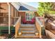 Wooden deck with stairs, two red chairs, and planters at 1441 Waterside Ct, Mount Pleasant, SC 29464
