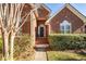 Front entry with brick facade and a green door at 1441 Waterside Ct, Mount Pleasant, SC 29464