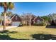 Brick home with attached garage and manicured lawn at 1441 Waterside Ct, Mount Pleasant, SC 29464