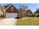 Brick home with attached two-car garage and landscaped yard at 1441 Waterside Ct, Mount Pleasant, SC 29464