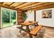 Rustic dining area with a wooden picnic table and access to the backyard at 15717 Round O Rd, Round O, SC 29474