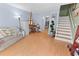 Living room with hardwood floors, light walls, and a view to the kitchen and stairs at 1820 Mepkin Rd # B6, Charleston, SC 29407