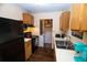 Galley kitchen with black appliances and wood cabinets at 1905 Central Park Rd # B, Charleston, SC 29412