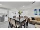 Bright dining area with a large table and six chairs, adjacent to a kitchen and living room at 211 Decoy Ln, Moncks Corner, SC 29461