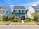 Two-story green house with white trim, landscaping, and American flag at 213 Oak View Way, Summerville, SC 29483