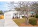 Newly renovated white ranch home with a two-car garage and manicured lawn at 2260 Woodland Shores Rd, Charleston, SC 29412