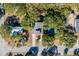 Aerial view of a house with a deck, surrounded by trees and a street at 2305 Myrtle St, Edisto Beach, SC 29438