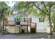 Back view of a house with a deck and trees at 2305 Myrtle St, Edisto Beach, SC 29438