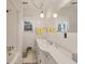 Bright bathroom with a white vanity, a bathtub, and yellow towels at 2305 Myrtle St, Edisto Beach, SC 29438
