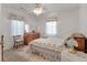 Cozy bedroom with a floral bedspread, a wooden dresser, and two large windows at 2305 Myrtle St, Edisto Beach, SC 29438