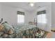 Inviting bedroom with a seashell-themed bedspread, a vanity, and a patterned rug at 2305 Myrtle St, Edisto Beach, SC 29438