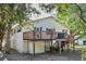 Two-story home with a wooden deck and stairs at 2305 Myrtle St, Edisto Beach, SC 29438