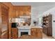 Kitchen with ample wooden cabinetry, white appliances, and views of the dining area at 2305 Myrtle St, Edisto Beach, SC 29438