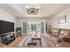 Living room featuring leather furniture, a large TV, and double doors leading to a sunroom at 2305 Myrtle St, Edisto Beach, SC 29438