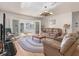 Inviting living area with leather couches, a rocking chair, and access to a bright sunroom at 2305 Myrtle St, Edisto Beach, SC 29438