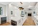 Open concept kitchen and living area with white cabinets and hardwood floors at 2719 Old Oak Walk, Seabrook Island, SC 29455