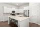 Modern kitchen with white cabinets, stainless steel appliances, and a large island at 282 Woodland Oak Way, Summerville, SC 29485