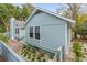 Quaint light blue home with landscaped yard and brick walkway at 4 Lake Village Ln, Isle of Palms, SC 29451