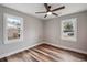 Spacious bedroom with ceiling fan and two windows at 4571 Garwood Dr, Ladson, SC 29456