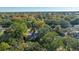 Aerial view showing home nestled in a wooded neighborhood with colorful trees at 46 Chadwick Dr, Charleston, SC 29407