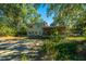 House backyard view with mature trees and screened porch at 46 Chadwick Dr, Charleston, SC 29407